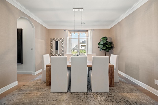 dining room with a chandelier, hardwood / wood-style floors, and ornamental molding