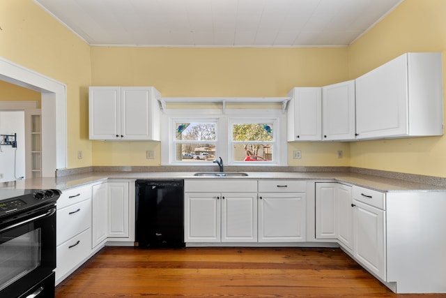 kitchen featuring black appliances, dark wood-type flooring, sink, and white cabinetry