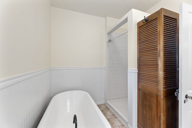 bathroom featuring separate shower and tub