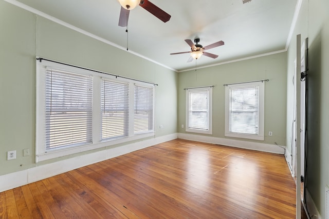 spare room featuring ceiling fan, crown molding, and light hardwood / wood-style floors