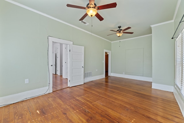 empty room featuring ceiling fan, ornamental molding, and hardwood / wood-style floors