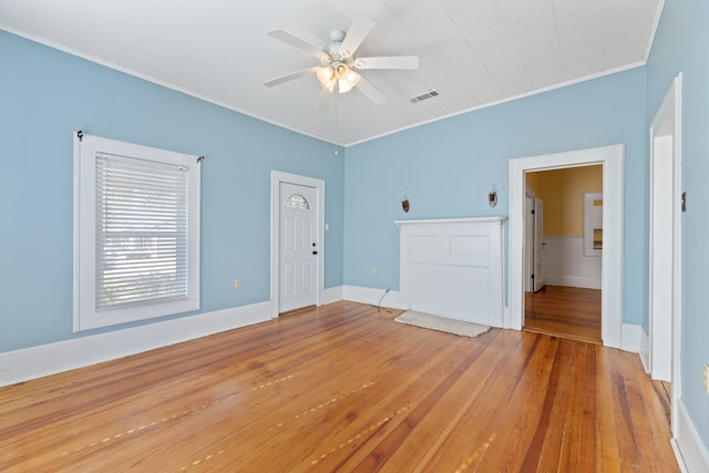 unfurnished room with ceiling fan, wood-type flooring, and ornamental molding