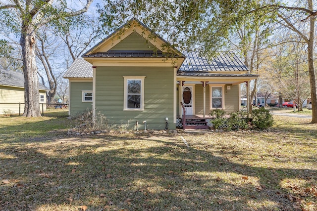 bungalow-style home with covered porch and a front yard