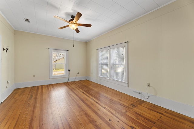 spare room with ceiling fan, crown molding, and hardwood / wood-style flooring