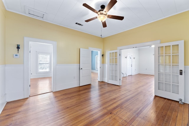 spare room featuring ceiling fan, hardwood / wood-style floors, and french doors