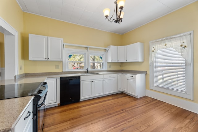 kitchen featuring decorative light fixtures, sink, white cabinetry, and black appliances