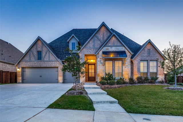 view of front of house with a garage and a yard