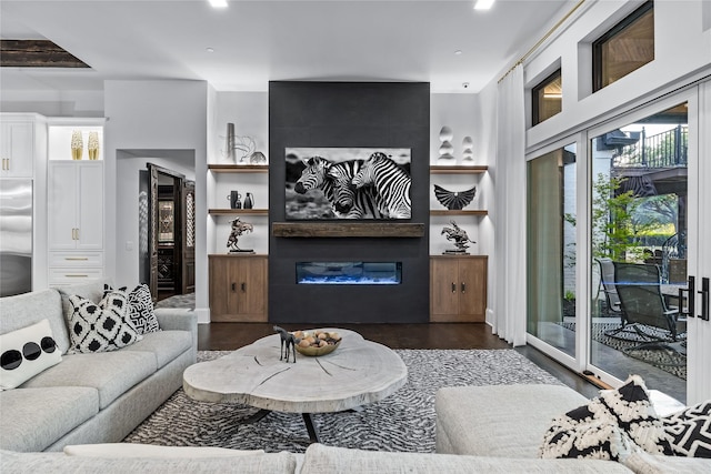 living room with beamed ceiling, a fireplace, and dark wood-type flooring