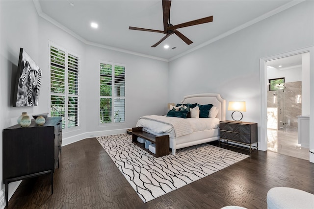 bedroom featuring connected bathroom, dark wood-type flooring, ceiling fan, and crown molding