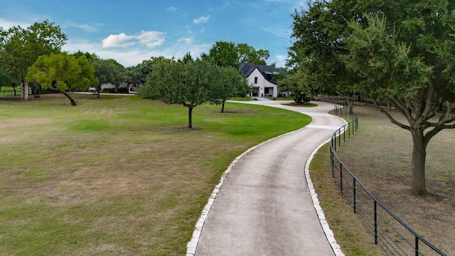 view of property's community with a lawn