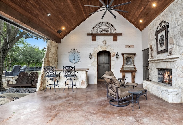 view of patio / terrace featuring an outdoor stone fireplace and ceiling fan