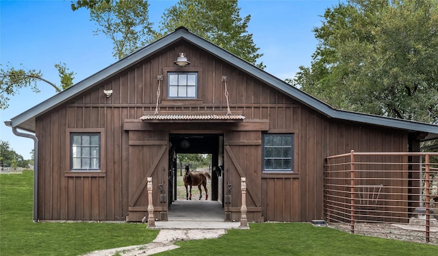 exterior space with an outbuilding and a front lawn