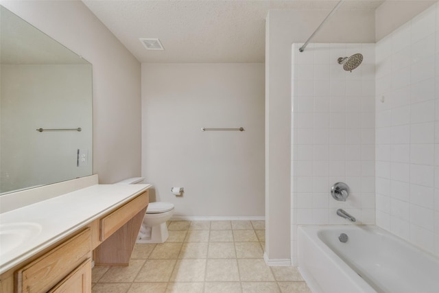 full bathroom featuring toilet, a textured ceiling, tiled shower / bath, and vanity