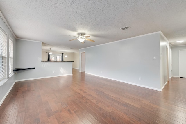 unfurnished living room featuring ceiling fan, crown molding, and a wealth of natural light