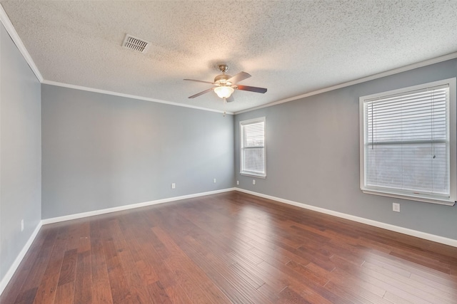 empty room with a textured ceiling, ceiling fan, ornamental molding, and hardwood / wood-style floors