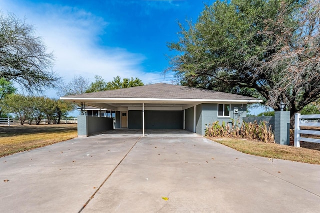 exterior space featuring a carport and a lawn