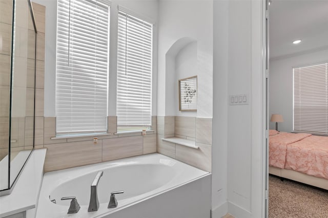 bathroom with a tub to relax in