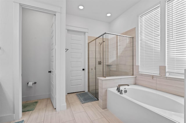 bathroom featuring tile patterned floors and separate shower and tub