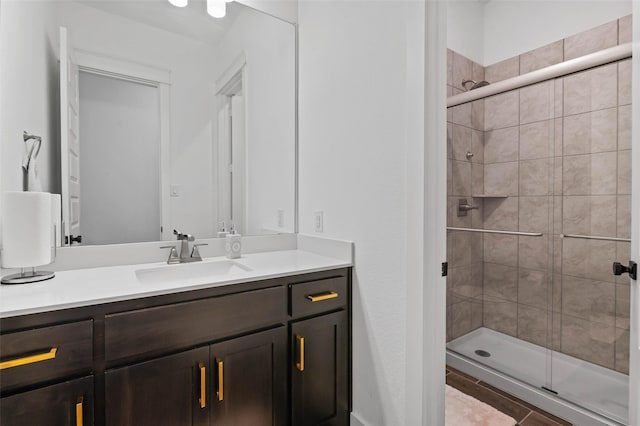 bathroom with tile patterned floors, vanity, and an enclosed shower