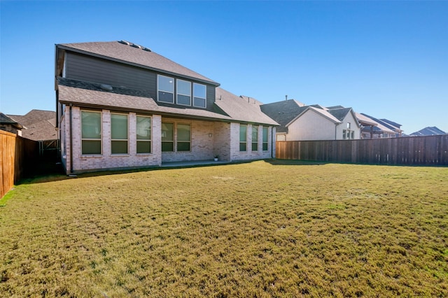 rear view of property featuring a yard