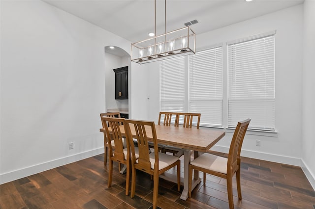 dining space featuring dark hardwood / wood-style flooring