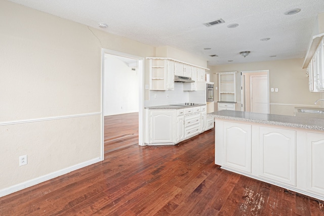 kitchen with black electric stovetop, stainless steel oven, dark wood-type flooring, sink, and white cabinets