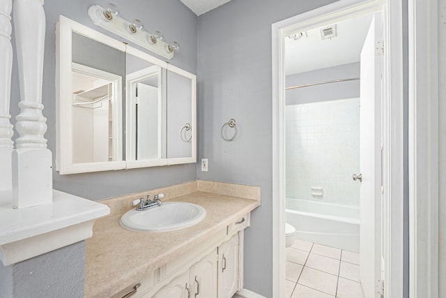 full bathroom with tile patterned flooring, vanity, toilet, and tiled shower / bath combo