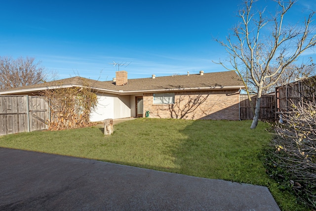 rear view of property with a lawn