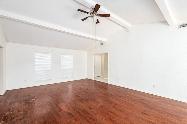 empty room with ceiling fan, lofted ceiling with beams, a textured ceiling, and hardwood / wood-style flooring