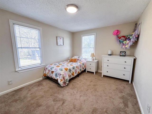 bedroom with light carpet and a textured ceiling