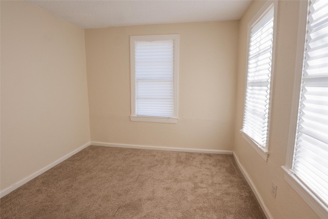 bedroom featuring light carpet, a raised ceiling, and ceiling fan