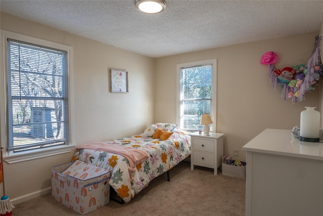 carpeted bedroom with a textured ceiling