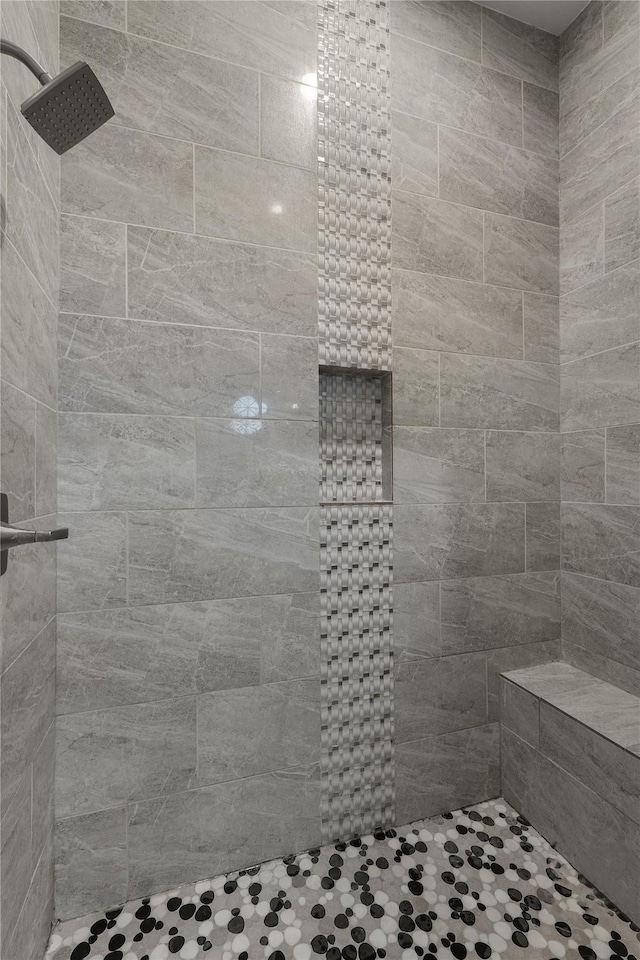 bathroom with tiled shower