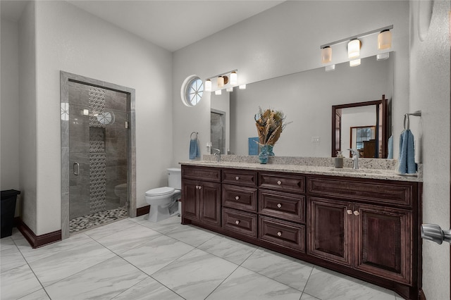 bathroom with vanity, toilet, and a shower with shower door