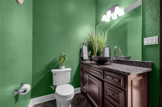 bathroom with tile patterned floors, vanity, and toilet