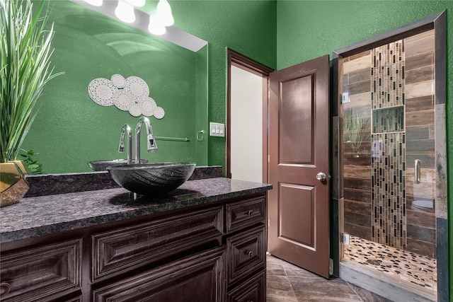 bathroom with vanity and tiled shower