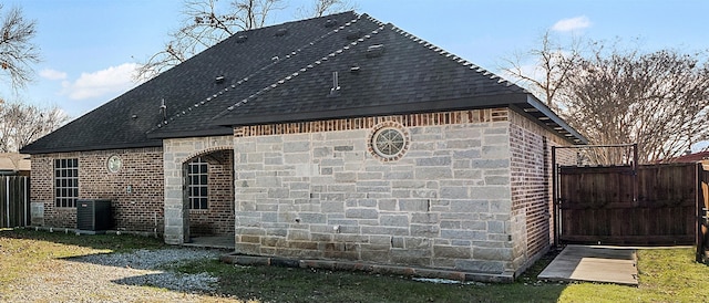 view of home's exterior featuring a yard and central AC