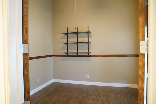 spare room with dark wood-type flooring