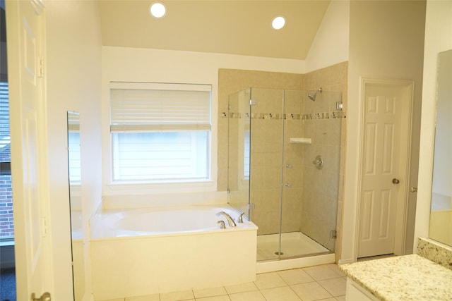 bathroom with tile patterned flooring, vanity, independent shower and bath, and lofted ceiling