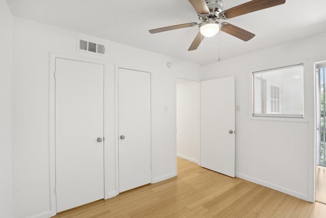 unfurnished bedroom featuring light wood-type flooring and ceiling fan