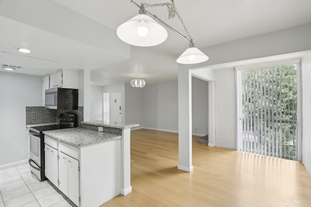 kitchen featuring white cabinetry, backsplash, range with electric cooktop, decorative light fixtures, and kitchen peninsula