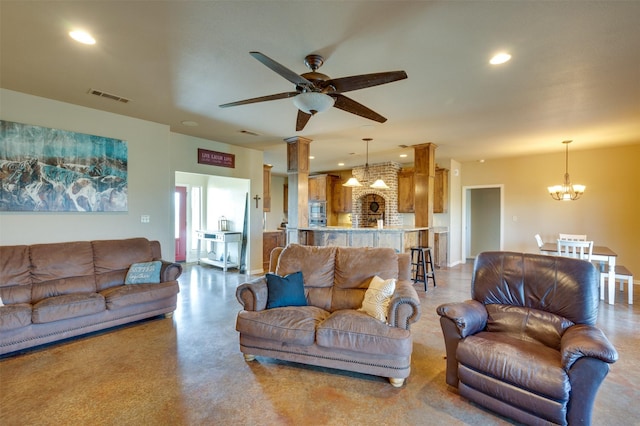 living room with ceiling fan with notable chandelier