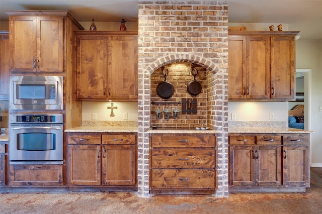 kitchen with light stone counters and stainless steel appliances