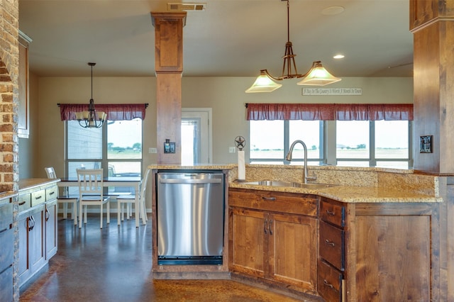 kitchen with pendant lighting, dishwasher, light stone countertops, and sink