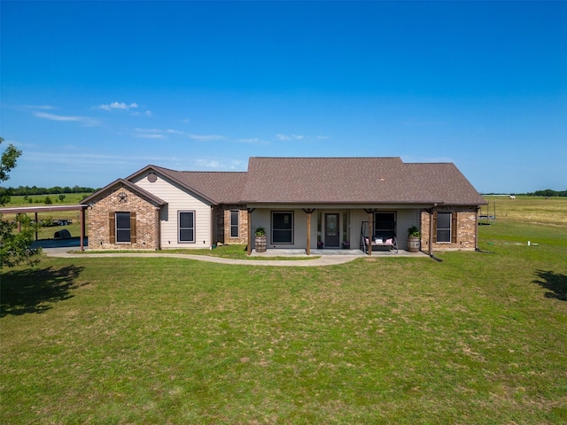 rear view of property featuring a lawn