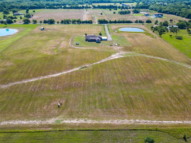 drone / aerial view featuring a rural view and a water view