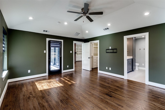 unfurnished room featuring ceiling fan, lofted ceiling, and dark wood-type flooring