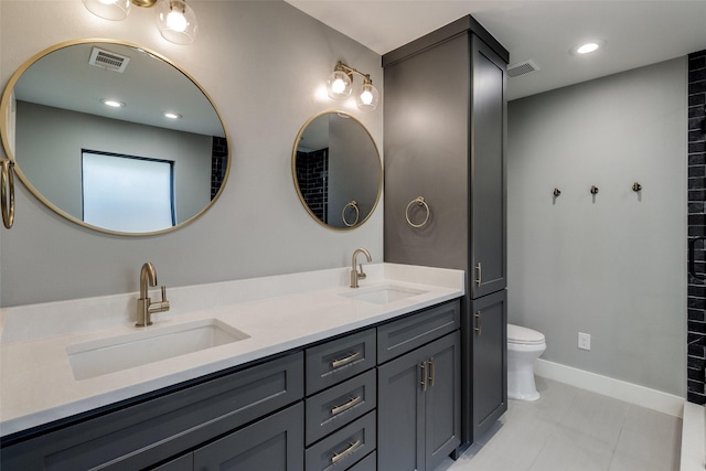 bathroom featuring tile patterned flooring, vanity, and toilet