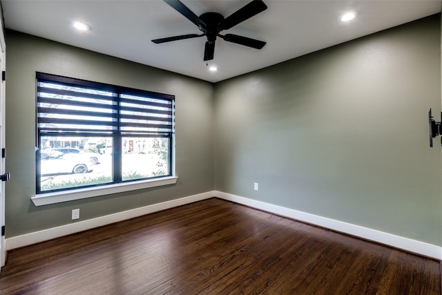 spare room featuring ceiling fan and dark wood-type flooring