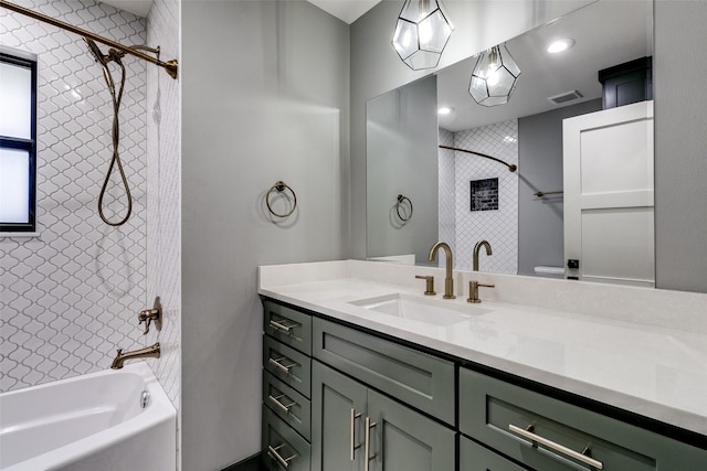 bathroom with vanity and tiled shower / bath combo